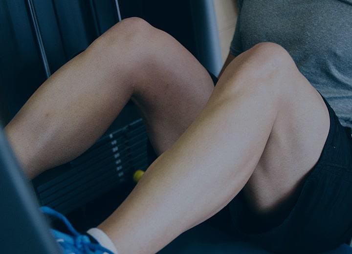 man exercising using a leg press machine